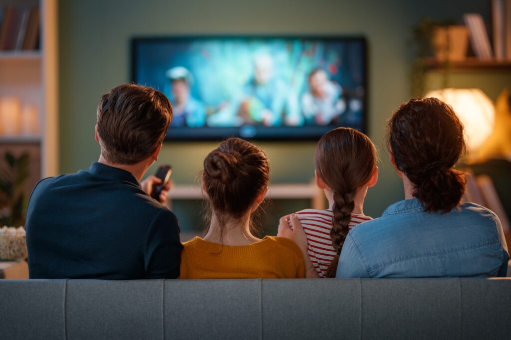 family watching TV in the evening at home